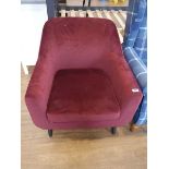 Modern maroon upholstered easy chair on black tapered supports