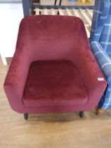 Modern maroon upholstered easy chair on black tapered supports