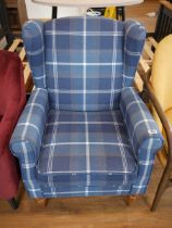 Modern blue check upholstered wing back easy chair on turned wooden supports
