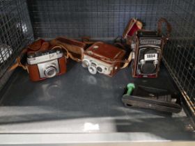 Cage containing various camera equipment to include Yashica 635, Contina and other models