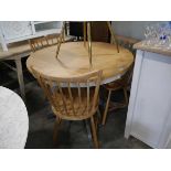 Single pedestal circular dining table with oak effect surface, together with a small side table