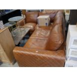 Tan corner sofa with diamond stitched arms together with a box containing the legs