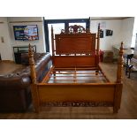 Carved hardwood double bedframe with decorative columns and fretwork detail
