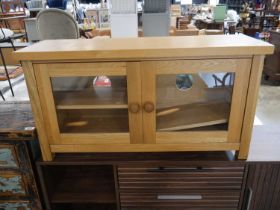 Modern light oak entertainment unit with glass doors