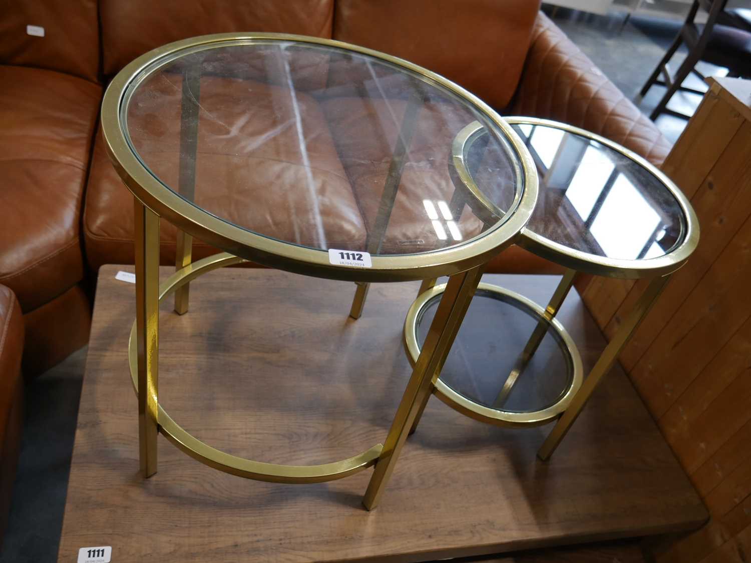 Set of 2 brass nesting coffee tables with glass shelving