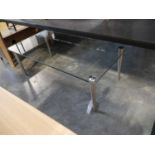 Glass topped coffee table on brushed chrome tapered supports