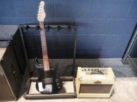 Children's electric guitar in black together with wash burn guitar amplifier