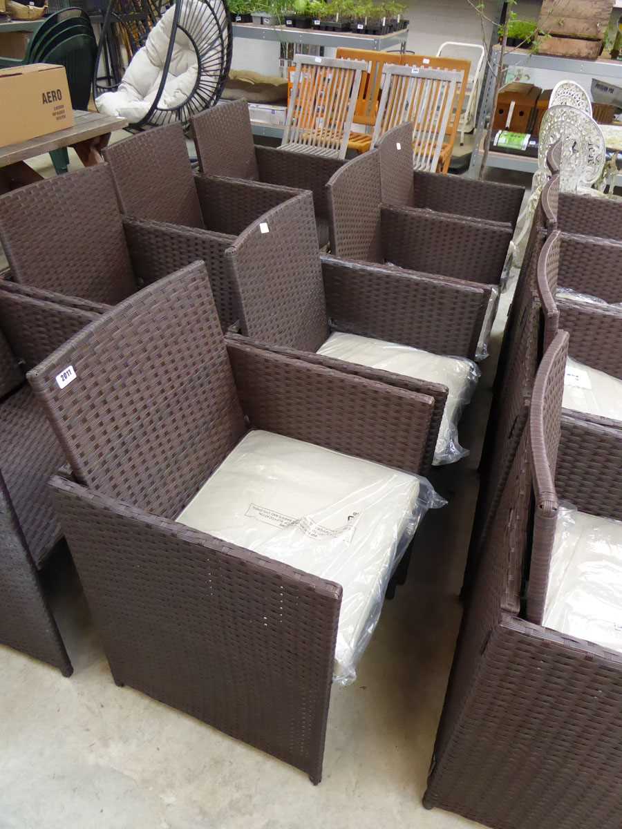 Set of 4 brown rattan garden chairs each with matching beige coloured cushions