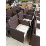 Set of 4 brown rattan garden chairs each with matching beige coloured cushions