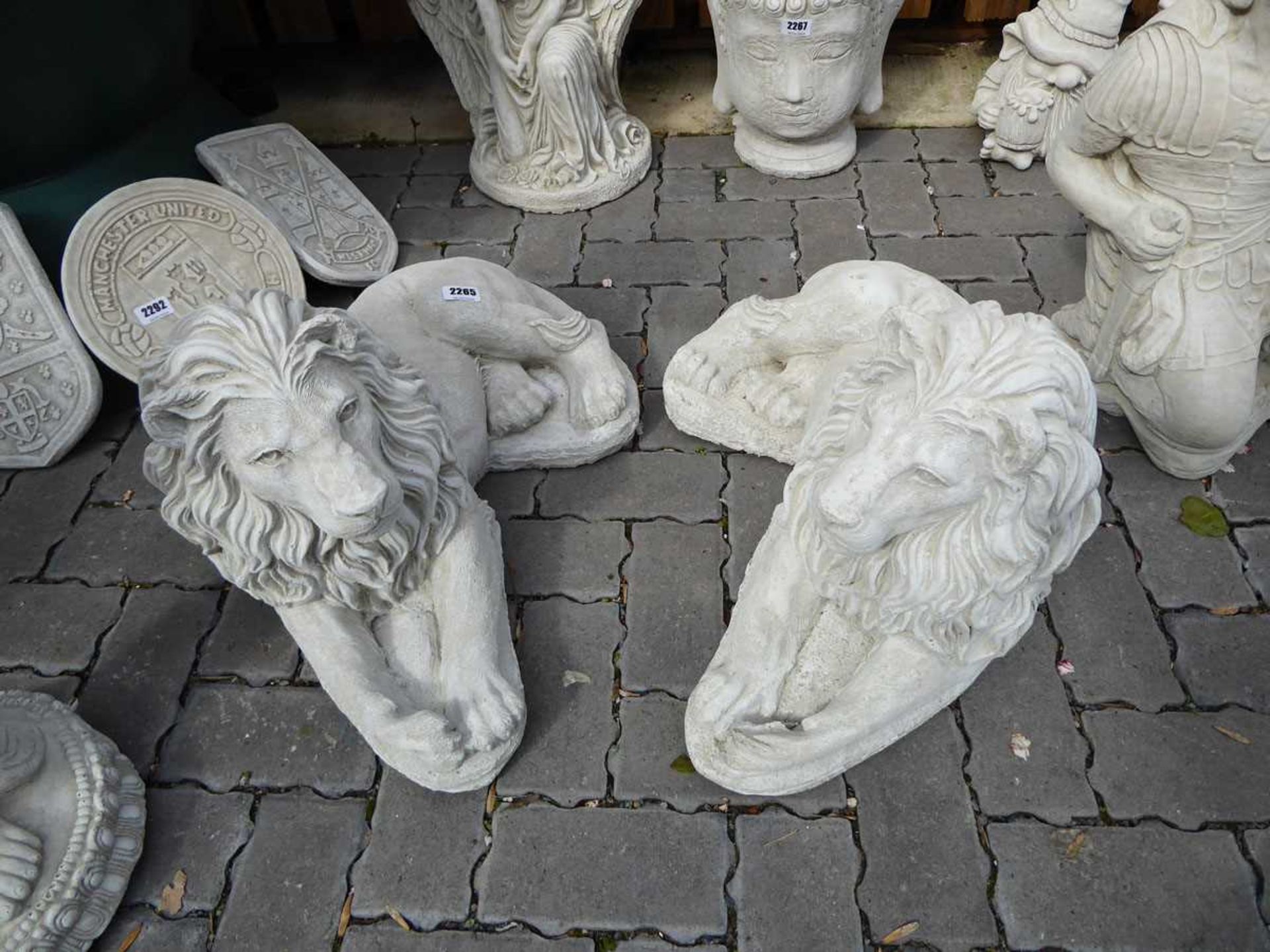 Pair of concrete laying down lions