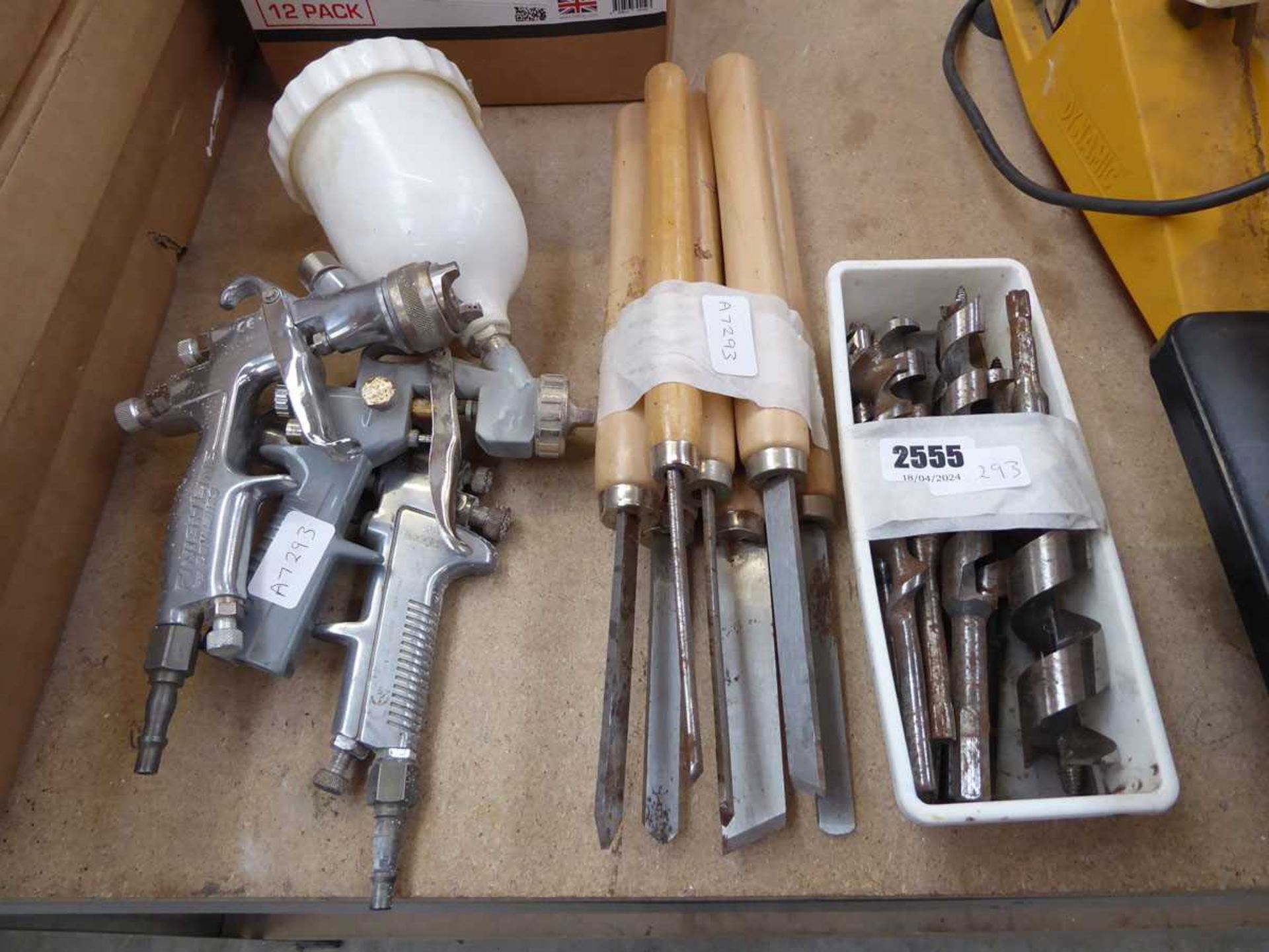 3 spray guns together with a quantity of carpenter's chisels and a Linbin of mixed size drill bits