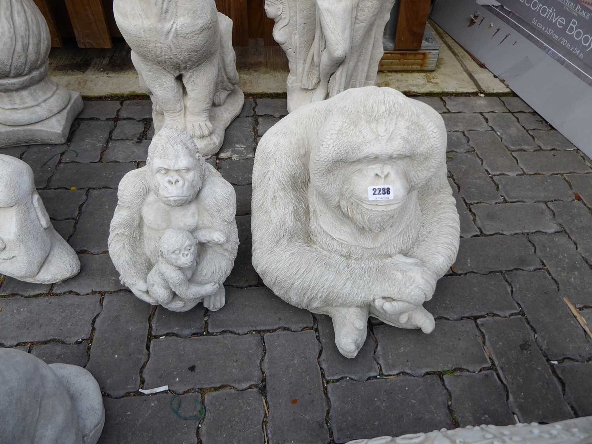 Large concrete orangutan, together with a concrete gorilla and baby