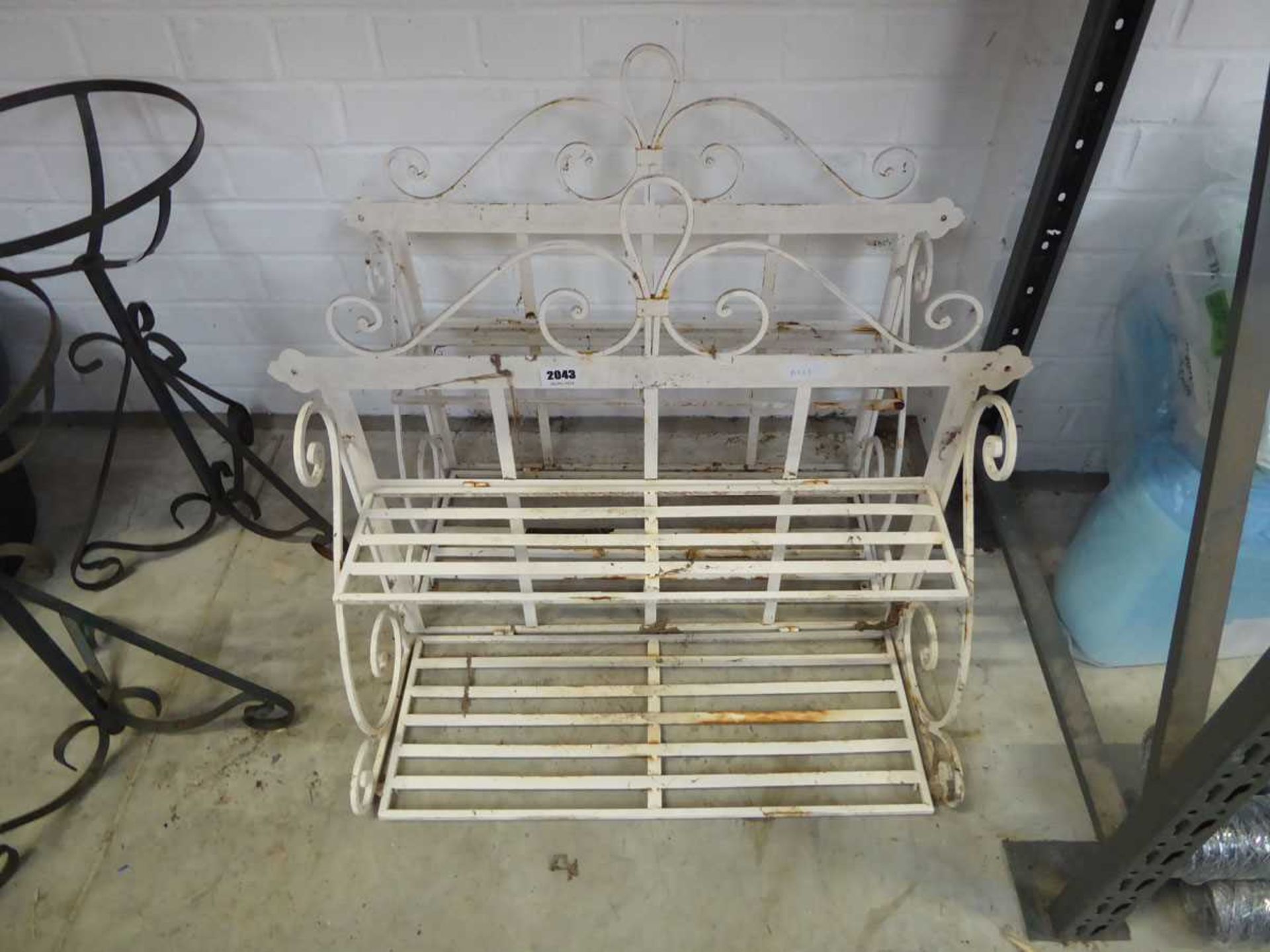 Pair of weathered wrought iron wall mounted outdoor shelves