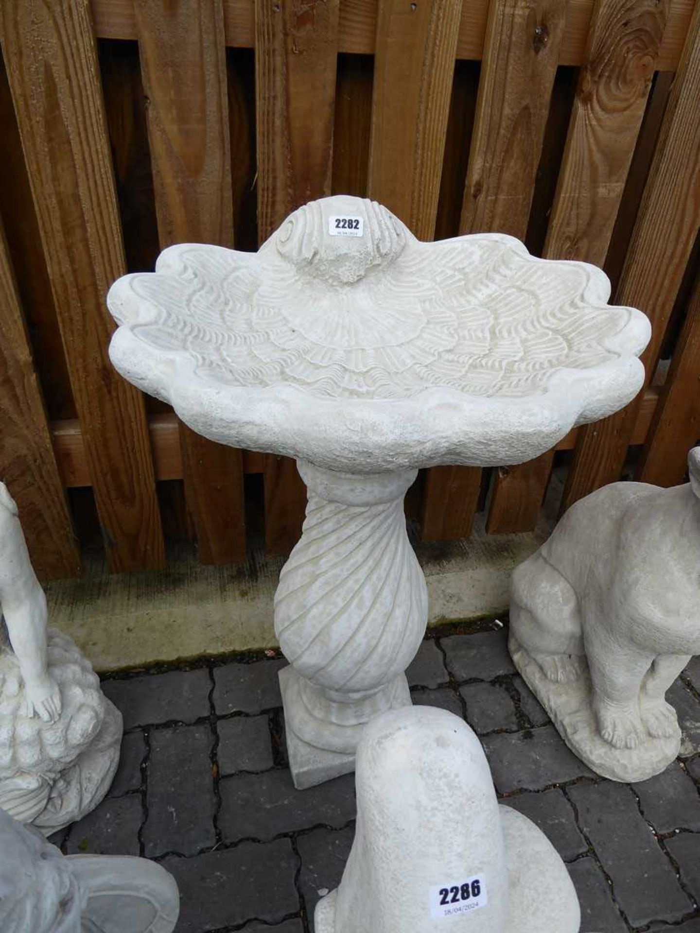 Concrete shell shaped bird bath