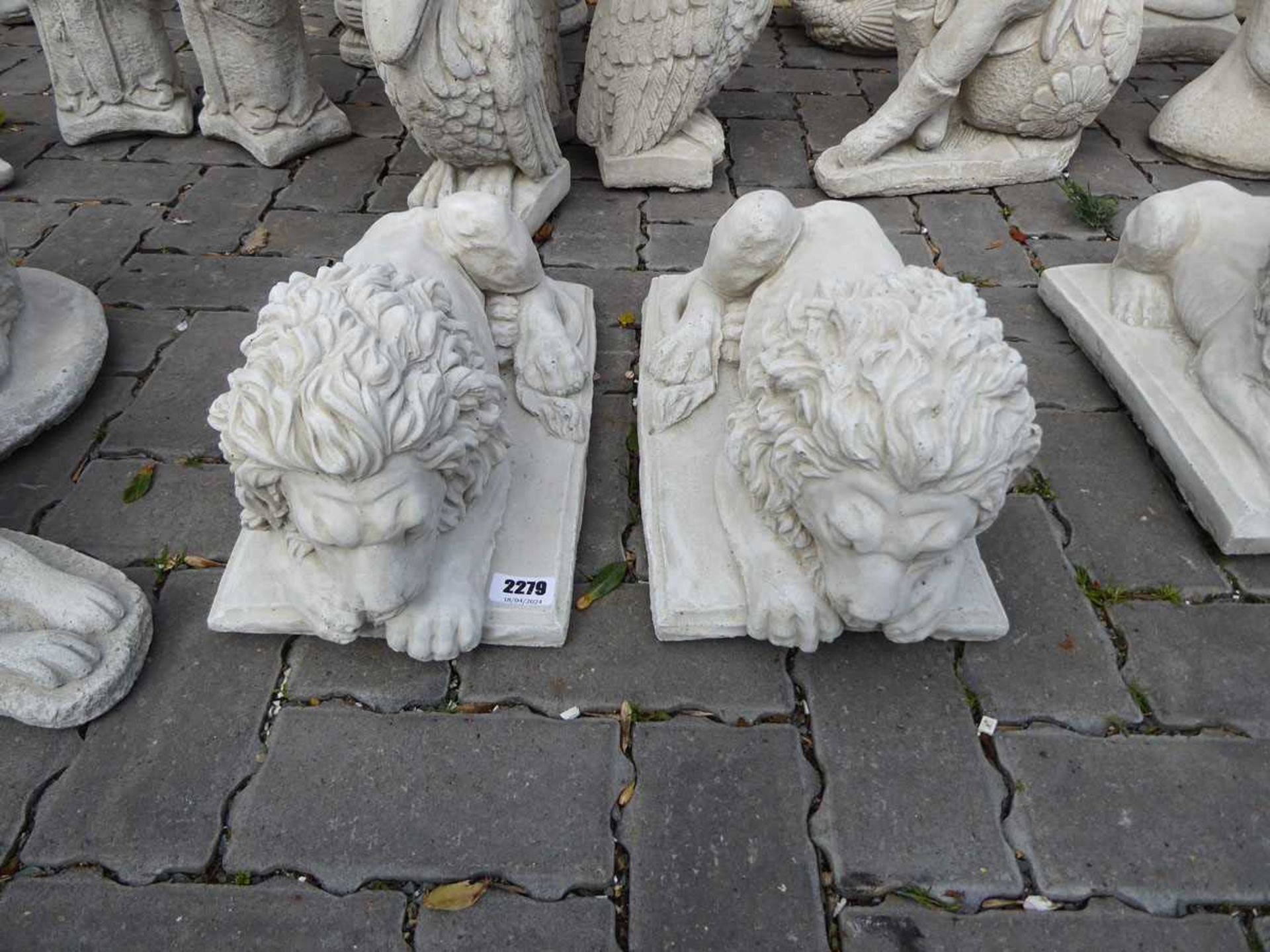 Pair of concrete laying down lions