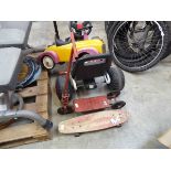Vintage metal 3 wheeled scooter together with a skateboard