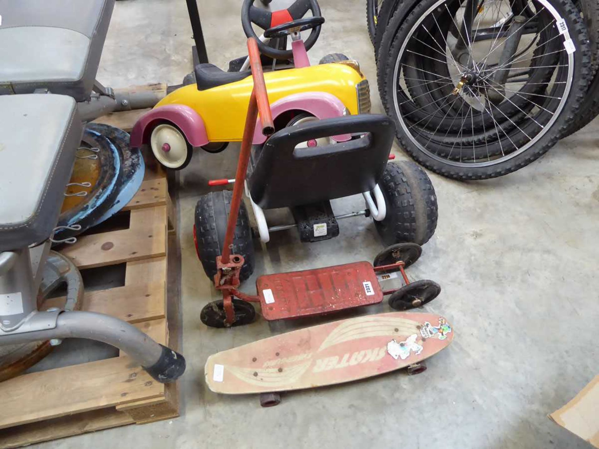 Vintage metal 3 wheeled scooter together with a skateboard