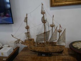 Handmade wooden model ship on stand