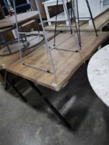 Hardwood finish dining table on black metal criss cross base