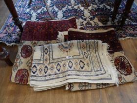 2 matching red, orange and beige figured and bordered rug, together with a further smaller rug on
