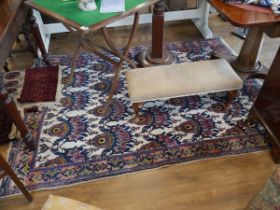 Red, blue, yellow and beige figured and bordered rug