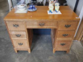 Honey oak writing desk with and arrangement of 7 drawers