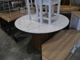 Circular dining table with marble effect surface and single pedestal ribbed wooden column shaped