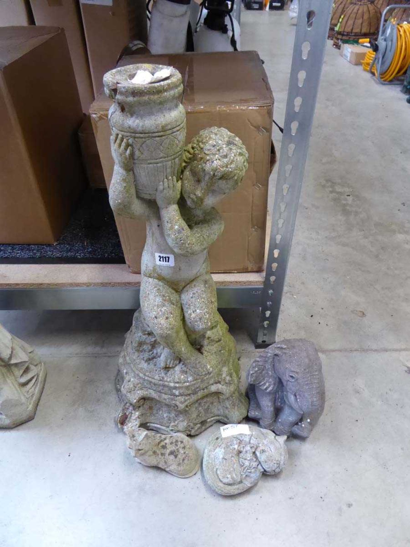 Concrete figurine of water boy on plinth together with 2 concrete cats and concrete elephant