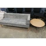 Blue upholstered commercial sofa together with circular topped coffee table