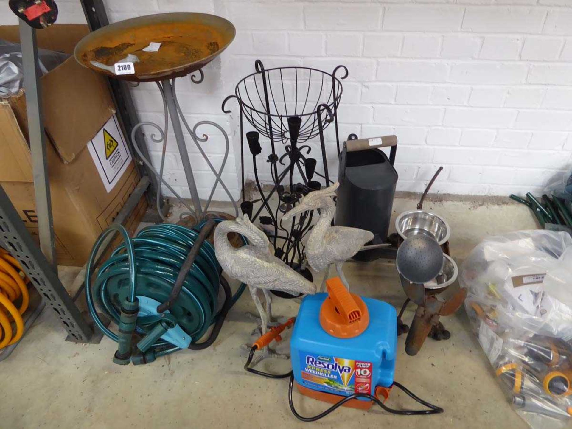 An assortment of decorative garden items to include weathered metal bird bath, pair of metal free