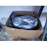 Box containing a large quantity of gazebo side curtains and covers