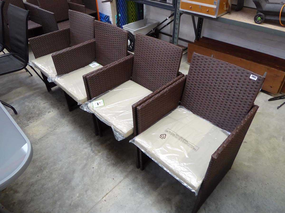 Set of 4 brown rattan garden armchairs each with matching beige cushions