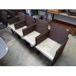 Set of 4 brown rattan garden armchairs each with matching beige cushions