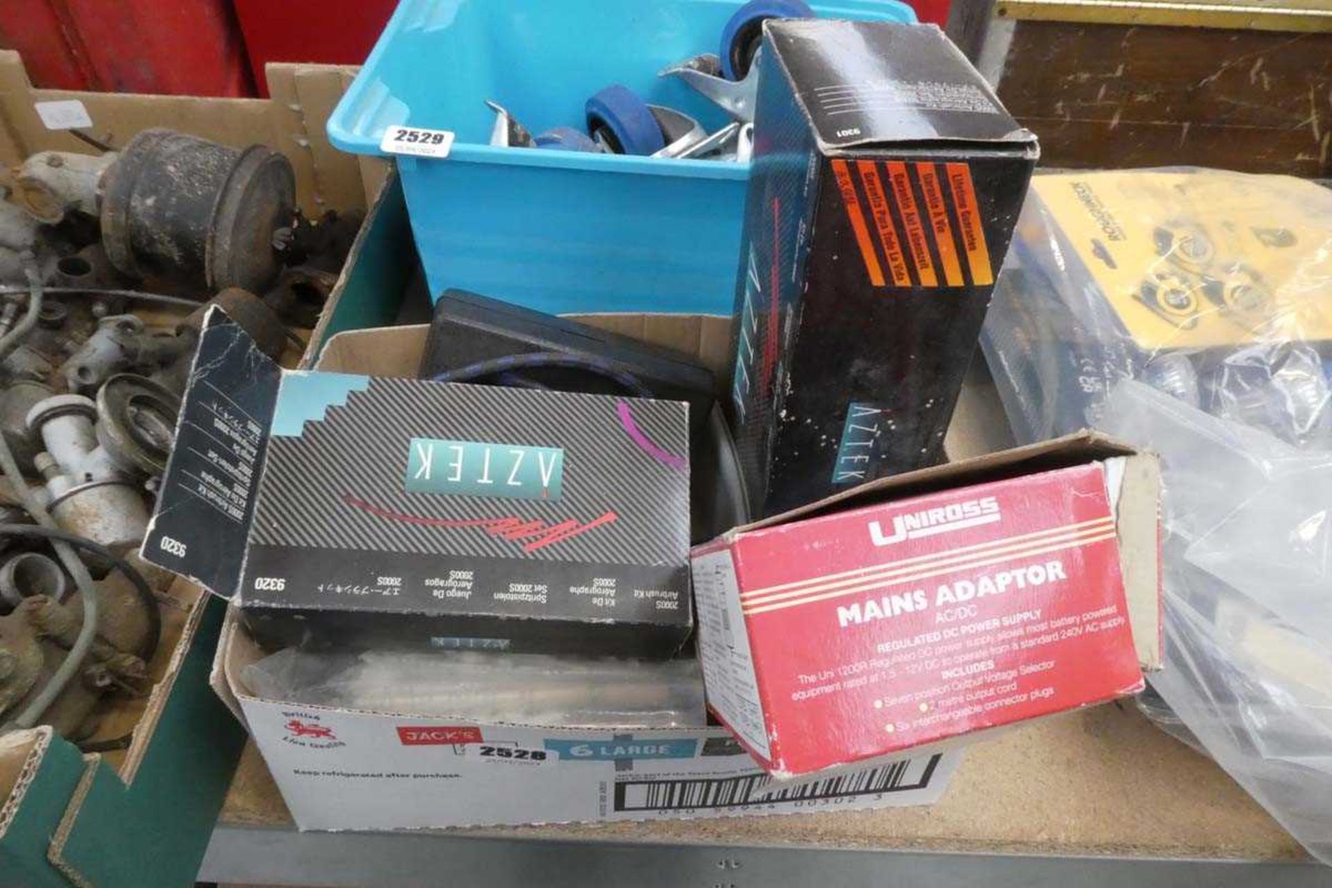 Crate containing qty of various items to include mains adapters, general purpose nozzle etc