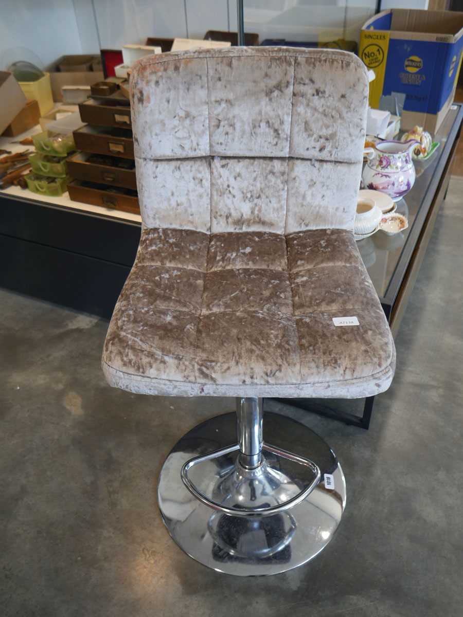 A modern metallic brown upholstered bar height stool on chrome supports