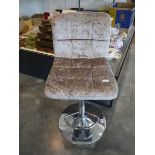 A modern metallic brown upholstered bar height stool on chrome supports
