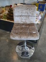 A modern metallic brown upholstered bar height stool on chrome supports
