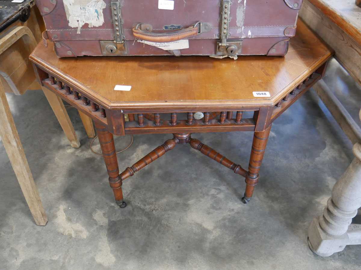 Octagonal mahogany centre table on castors