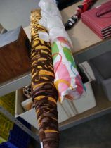 2 rolls of fabric (1 golden brown, 1 multi-coloured)