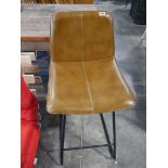 Bar height stool upholstered in tan leatherette finish