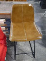 Bar height stool upholstered in tan leatherette finish