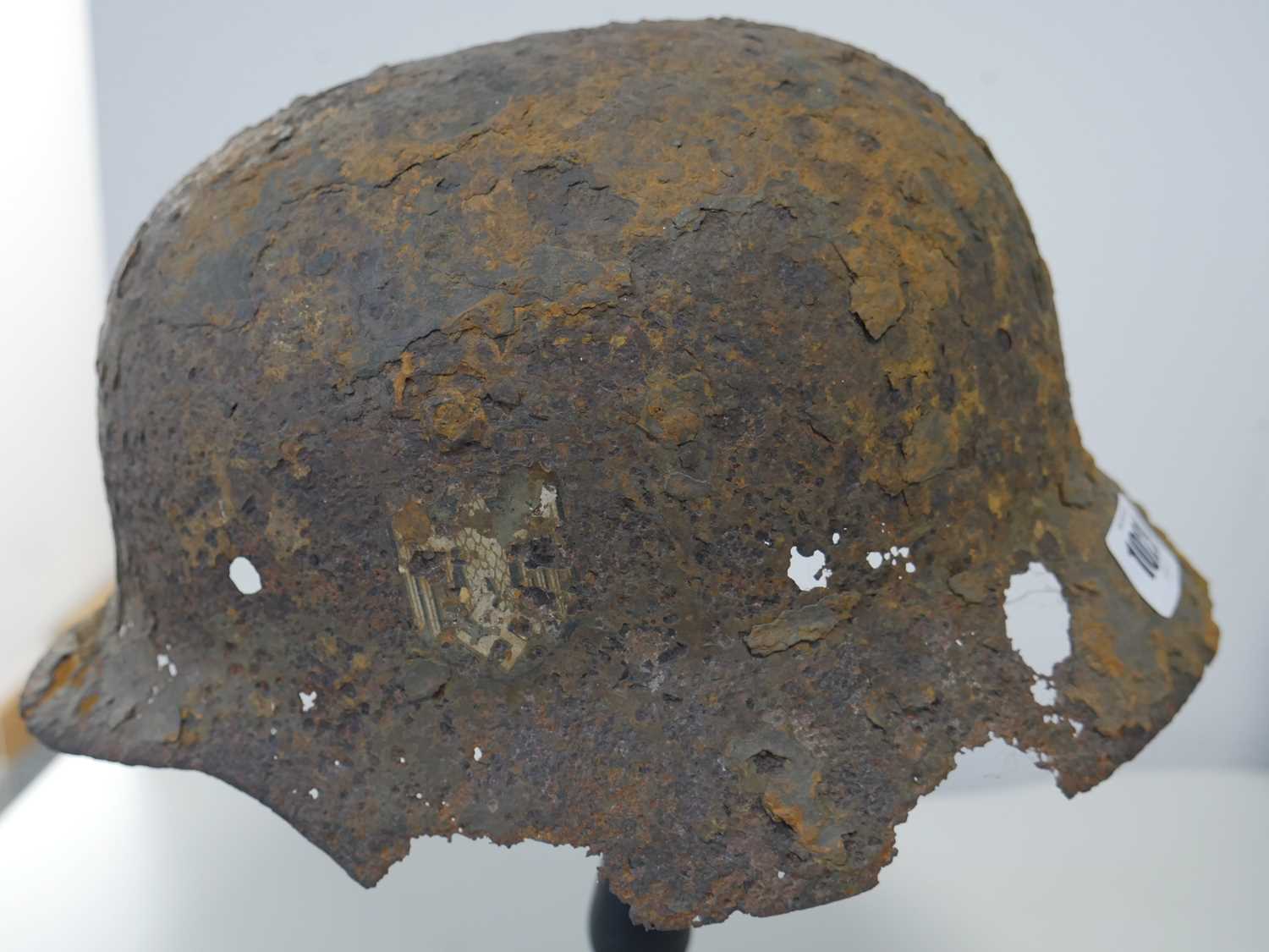 Military helmet bearing Nazi insignia on purpose built wooden stand Heavy rusting and deterioration - Image 3 of 6