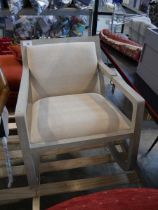 +VAT Grey wood finish rocking chair with natural coloured upholstered seat and back Some cracking to