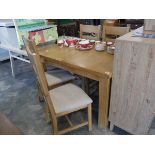 Modern light oak extending dining table with 4 grey upholstered dining chairs