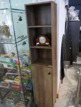 Hardwood finish slender cupboard with open front bookshelf over