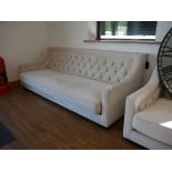 +VAT Low level beige upholstered button back sofa on black plinth type base
