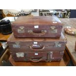 3 brown leather suitcases