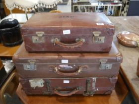 3 brown leather suitcases