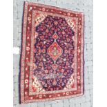 Red, blue and beige figured and bordered rug