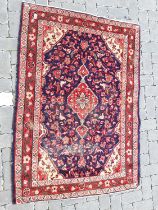 Red, blue and beige figured and bordered rug